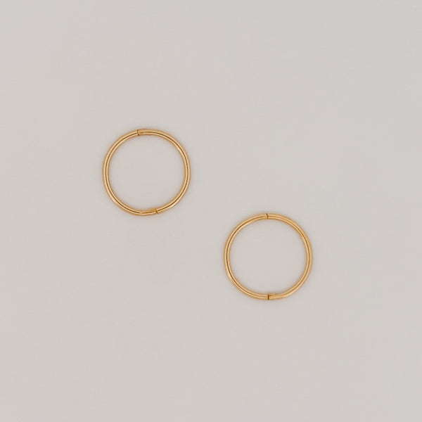 OLE sleeper hoops in solid 9ct yellow gold. Lightweight hinged earrings by AGOVIA.