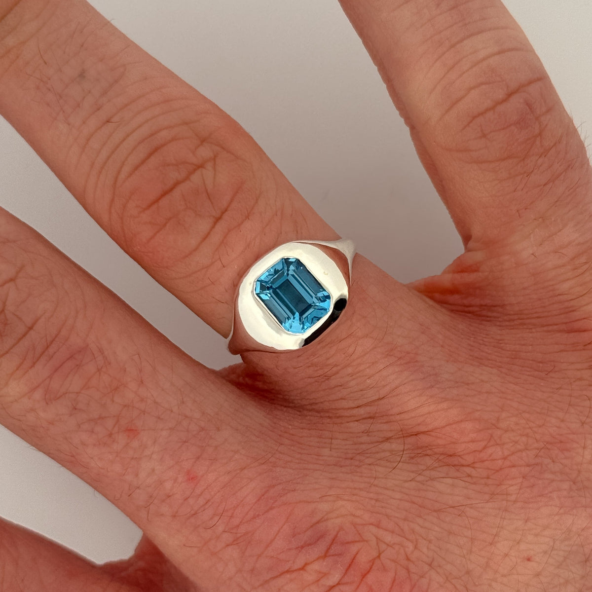 BELLO Ring in sterling silver, set with an emerald-cut Swiss blue topaz. Handmade in Melbourne by AGOVIA.