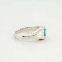 Silver ring with a blue gemstone on a white background
