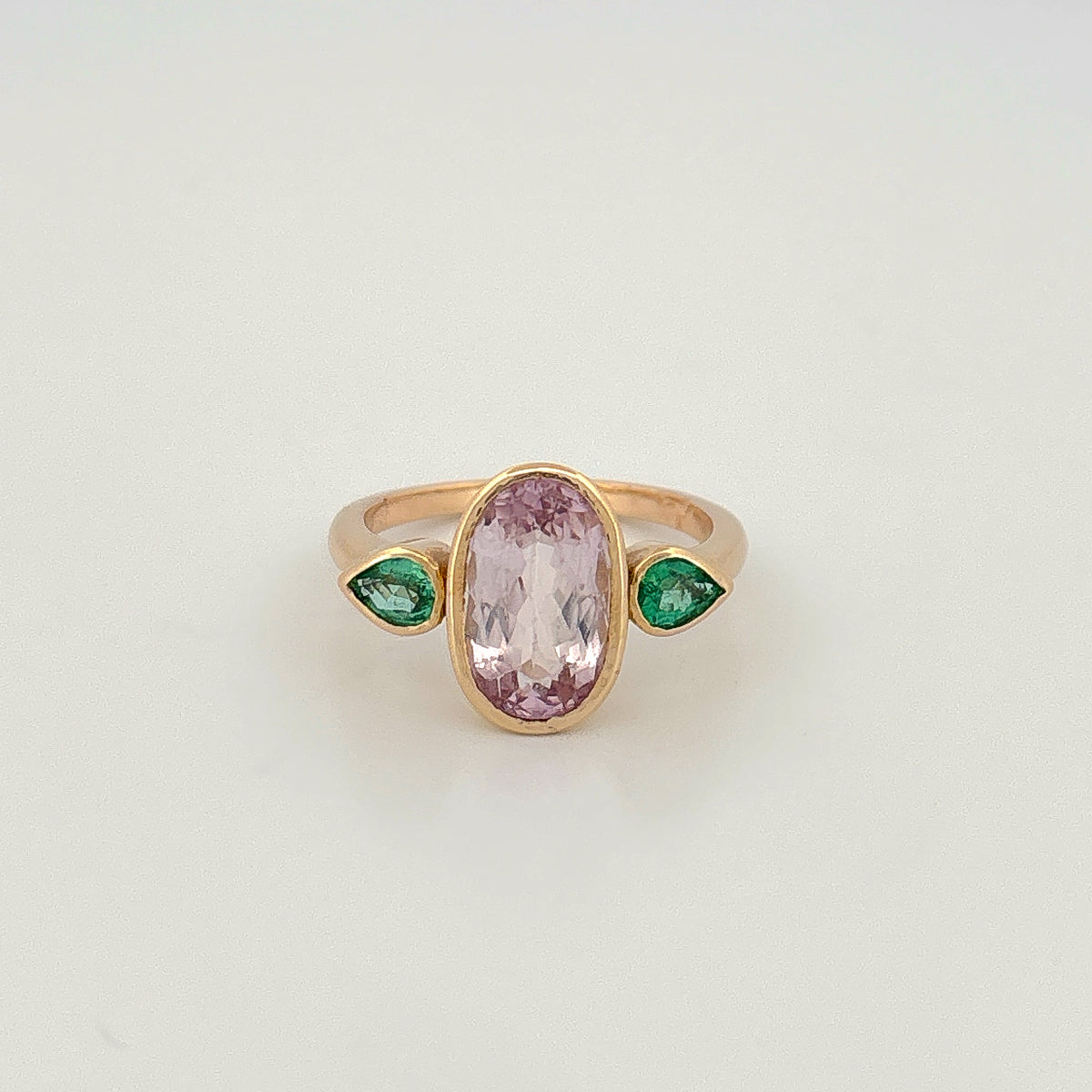 POLLYANNA Ring in 9ct yellow gold, set with a kunzite and two Zambian emeralds. One-of-one piece by AGOVIA Melbourne.