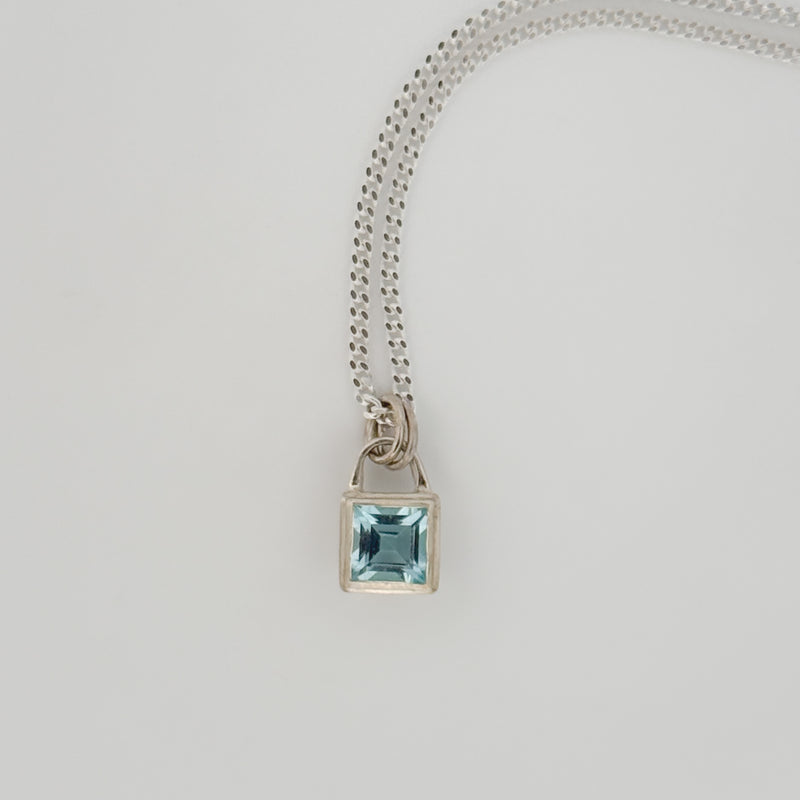 ATTICUS Pendant in sterling silver, set with a Swiss blue topaz on a diamond-cut curb chain. Handmade in Melbourne by AGOVIA.