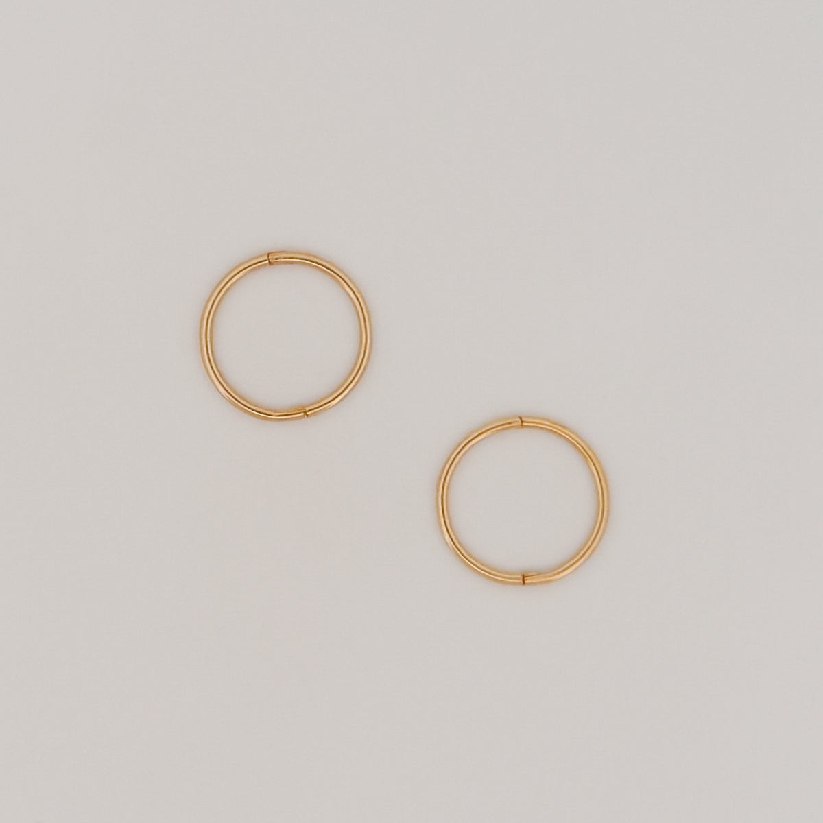 OLE sleeper hoops in solid 9ct yellow gold. Lightweight hinged earrings by AGOVIA.