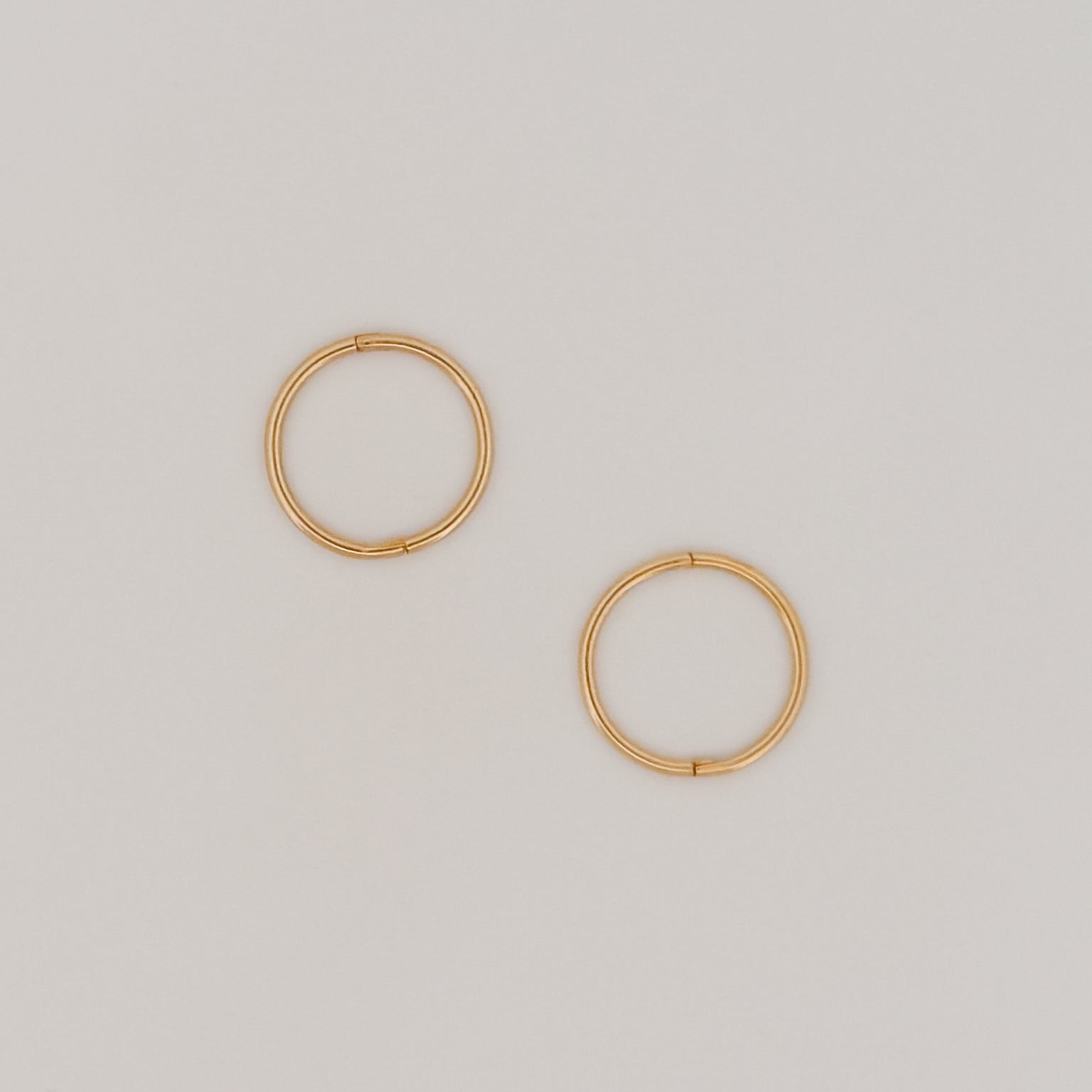 OLE sleeper hoops in solid 9ct yellow gold. Lightweight hinged earrings by AGOVIA.
