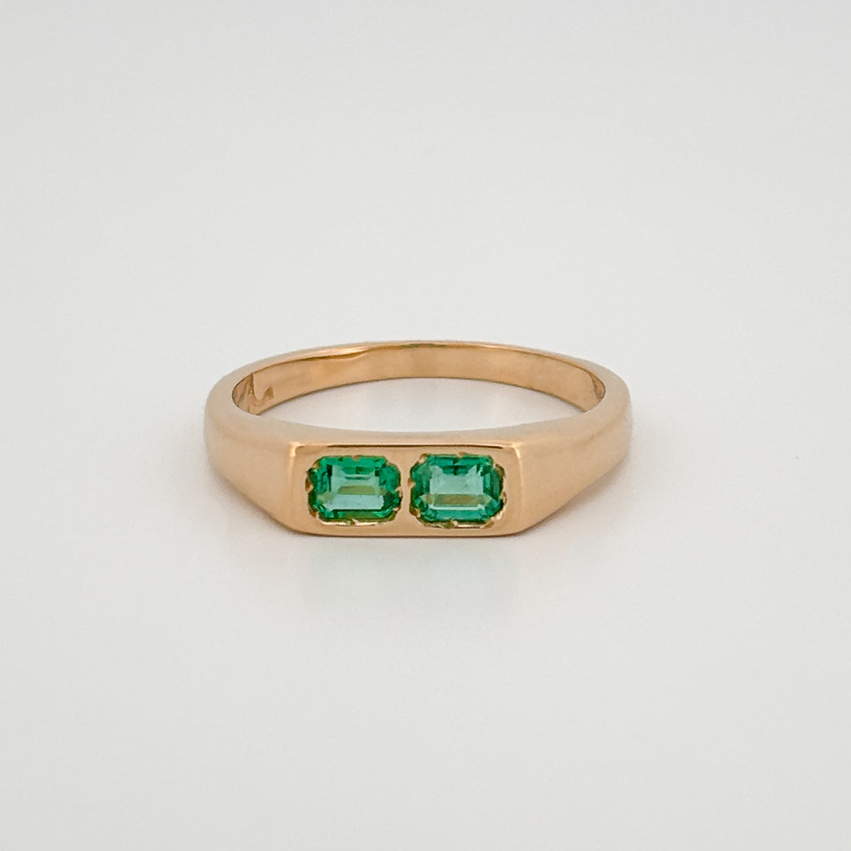 FELIX Ring in 18ct yellow gold, set with two emerald-cut Zambian emeralds. Handmade in Melbourne by AGOVIA.