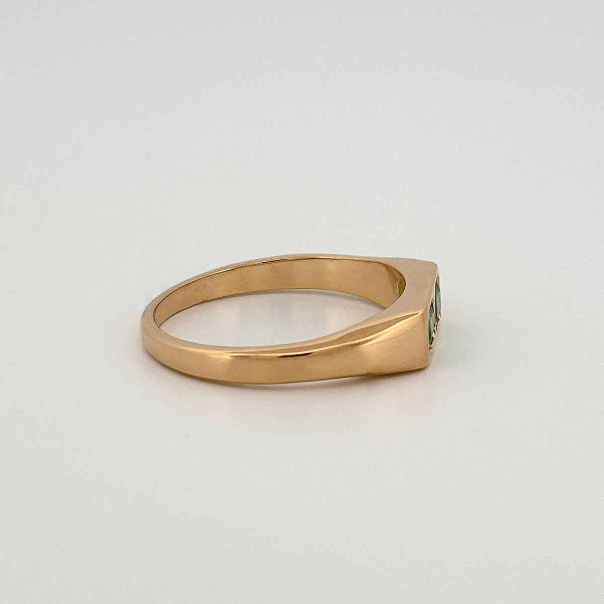 FELIX Ring in 18ct yellow gold, set with two emerald-cut Zambian emeralds. Handmade in Melbourne by AGOVIA.