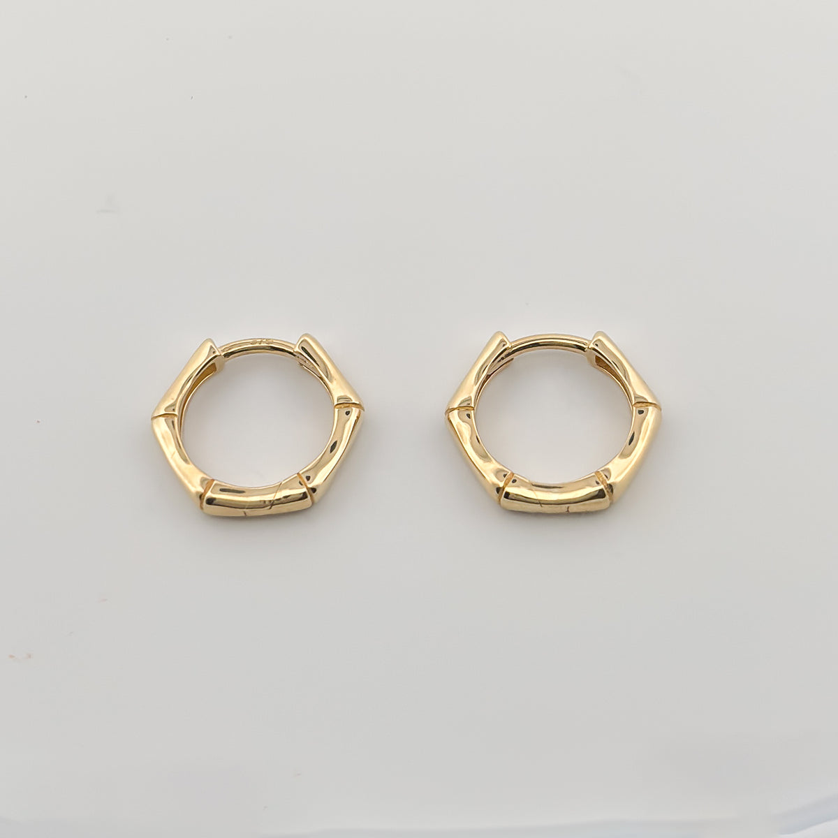 CALYPSO Hoops in solid 9ct or 18ct yellow gold, geometric rattan-inspired design. AGOVIA fine jewellery.