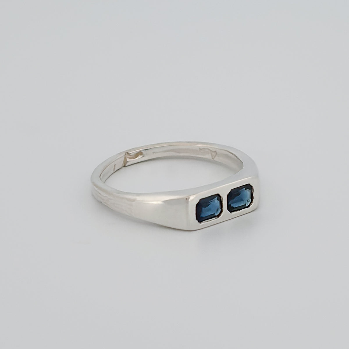 AYXA Ring in silver, set with an emerald-cut Australian blue sapphire. Handmade in Melbourne by AGOVIA.