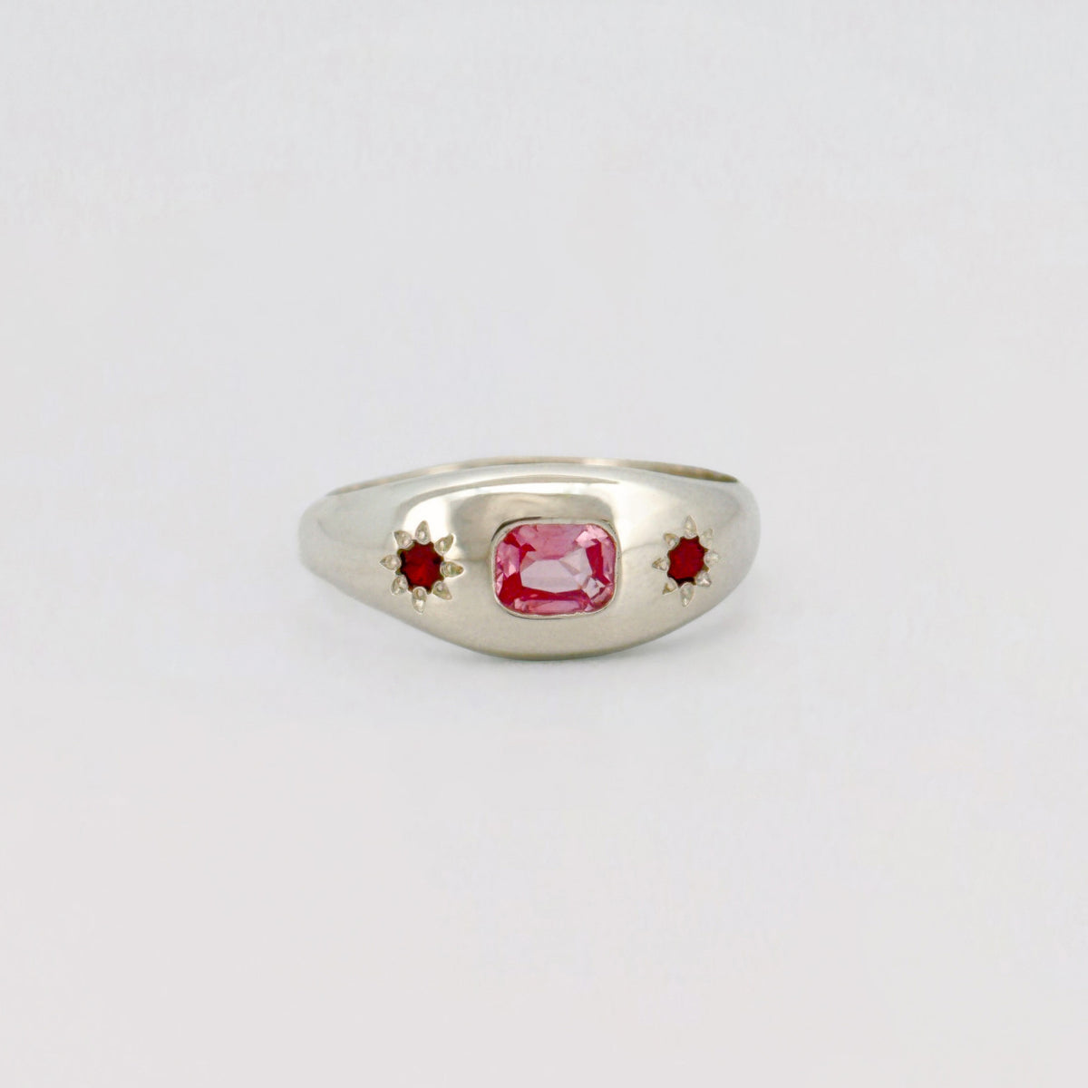 Siena Ring set with a cushion-cut pink sapphire and two star-set rubies. Handmade in Melbourne by AGOVIA.