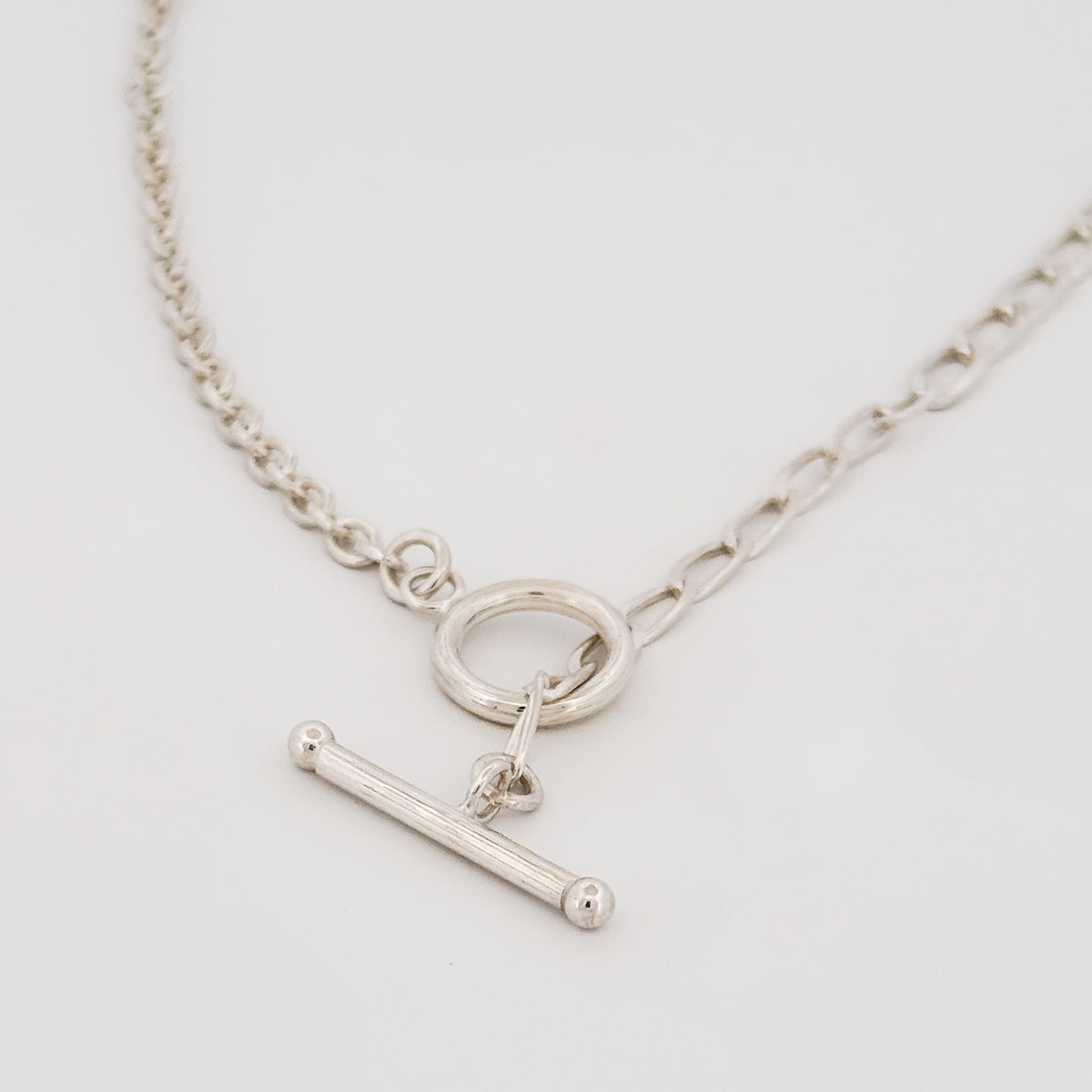 ATTIS Chain in sterling silver, combining curb and cable links with a fob clasp. Worn as a neck chain or doubled wrist chain. AGOVIA Melbourne.