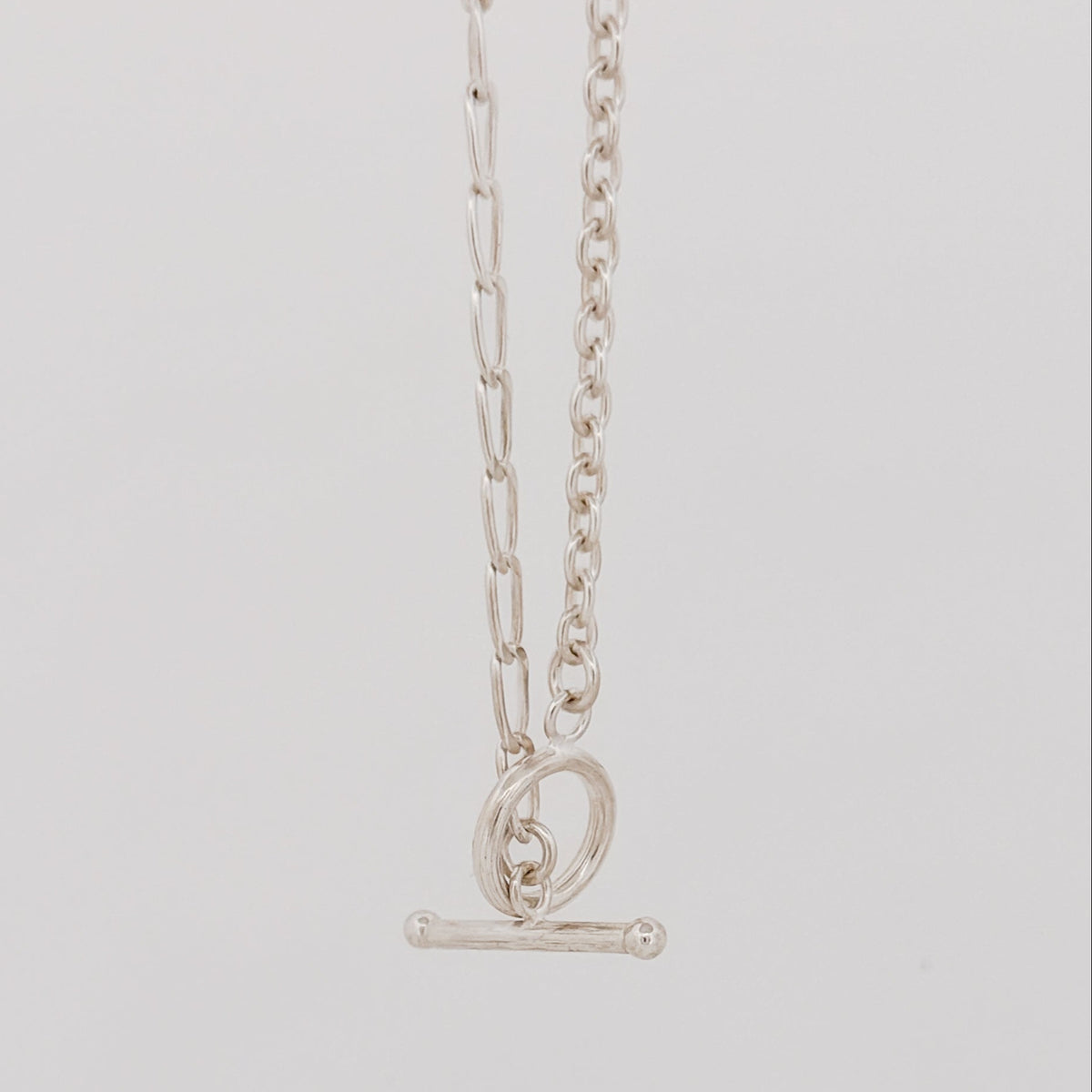 ATTIS Chain in sterling silver, combining curb and cable links with a fob clasp. Worn as a neck chain or doubled wrist chain. AGOVIA Melbourne.