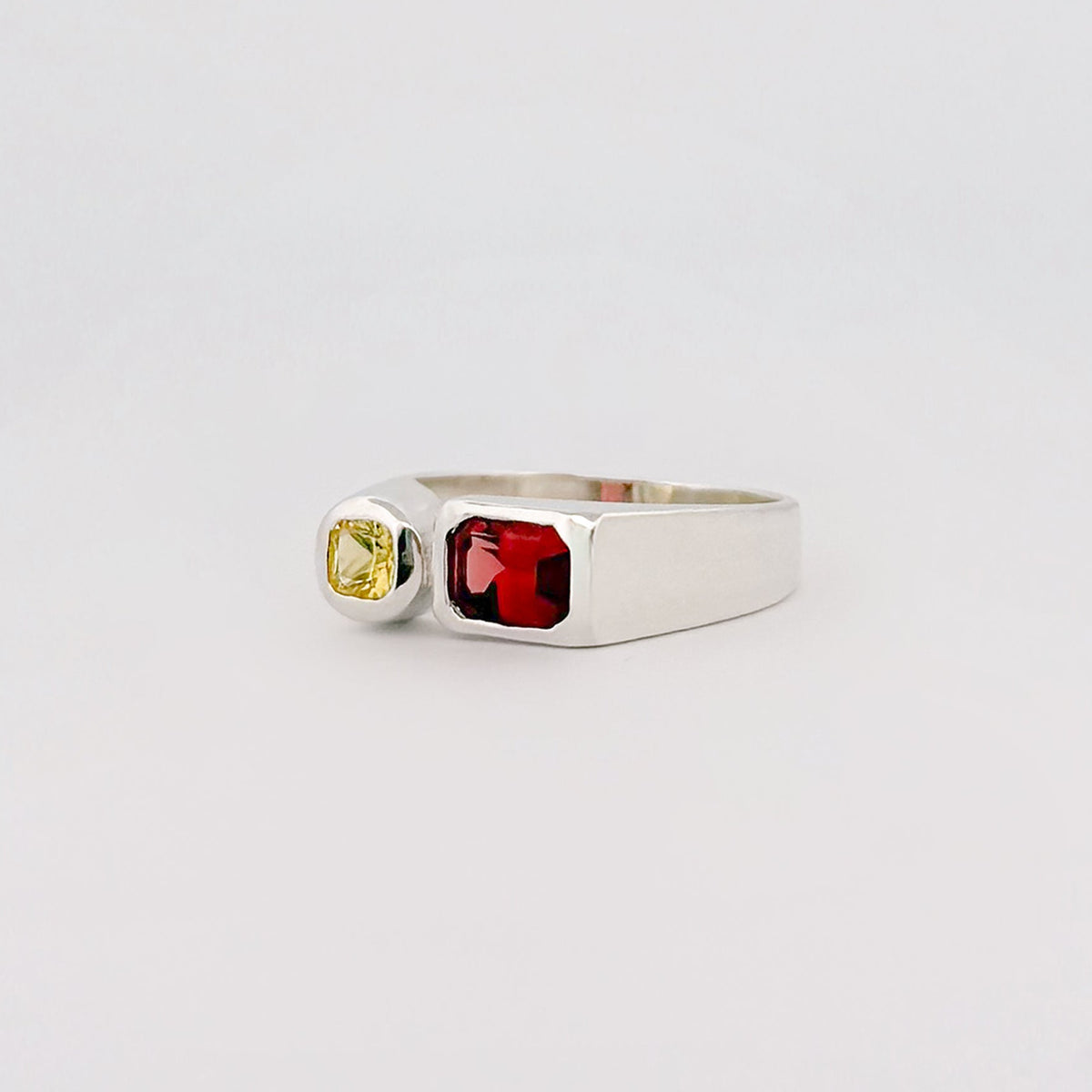 ARANSO IV Ring in sterling silver, set with an emerald-cut hessonite garnet and round Ceylon sapphire. Handmade in Melbourne by AGOVIA.