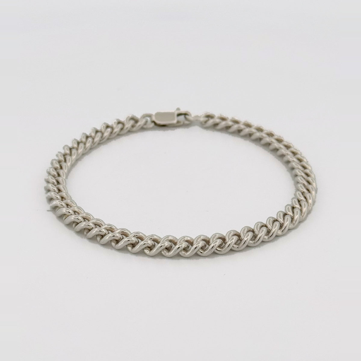 CASPER wrist chain in sterling silver, clasped, seen at an angle.
