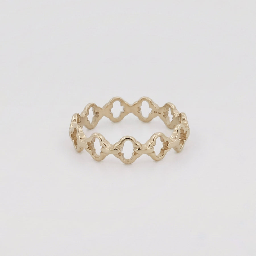 A silver ring and a chain laid on a pale ground