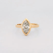 Marquise solitaire engagement ring with bezel-set diamond on a comfort-fit band. Available in recycled gold or platinum. Handmade in Melbourne by AGOVIA.