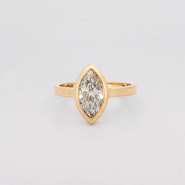 Marquise solitaire engagement ring with bezel-set diamond on a comfort-fit band. Available in gold or platinum. Handmade in Melbourne by AGOVIA.