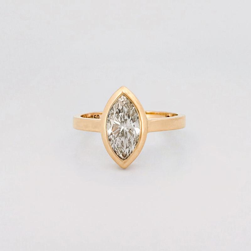 Marquise solitaire engagement ring with bezel-set diamond on a comfort-fit band. Available in gold or platinum. Handmade in Melbourne by AGOVIA.