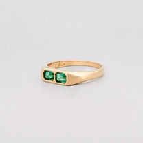 FELIX Ring in recycled 18ct yellow gold, set with two emerald-cut Zambian emeralds. Handmade in Melbourne by AGOVIA.