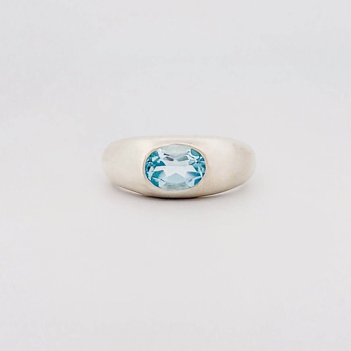 MANON Ring in sterling silver, set with a bezel-set oval Swiss blue topaz. Handmade in Melbourne by AGOVIA.