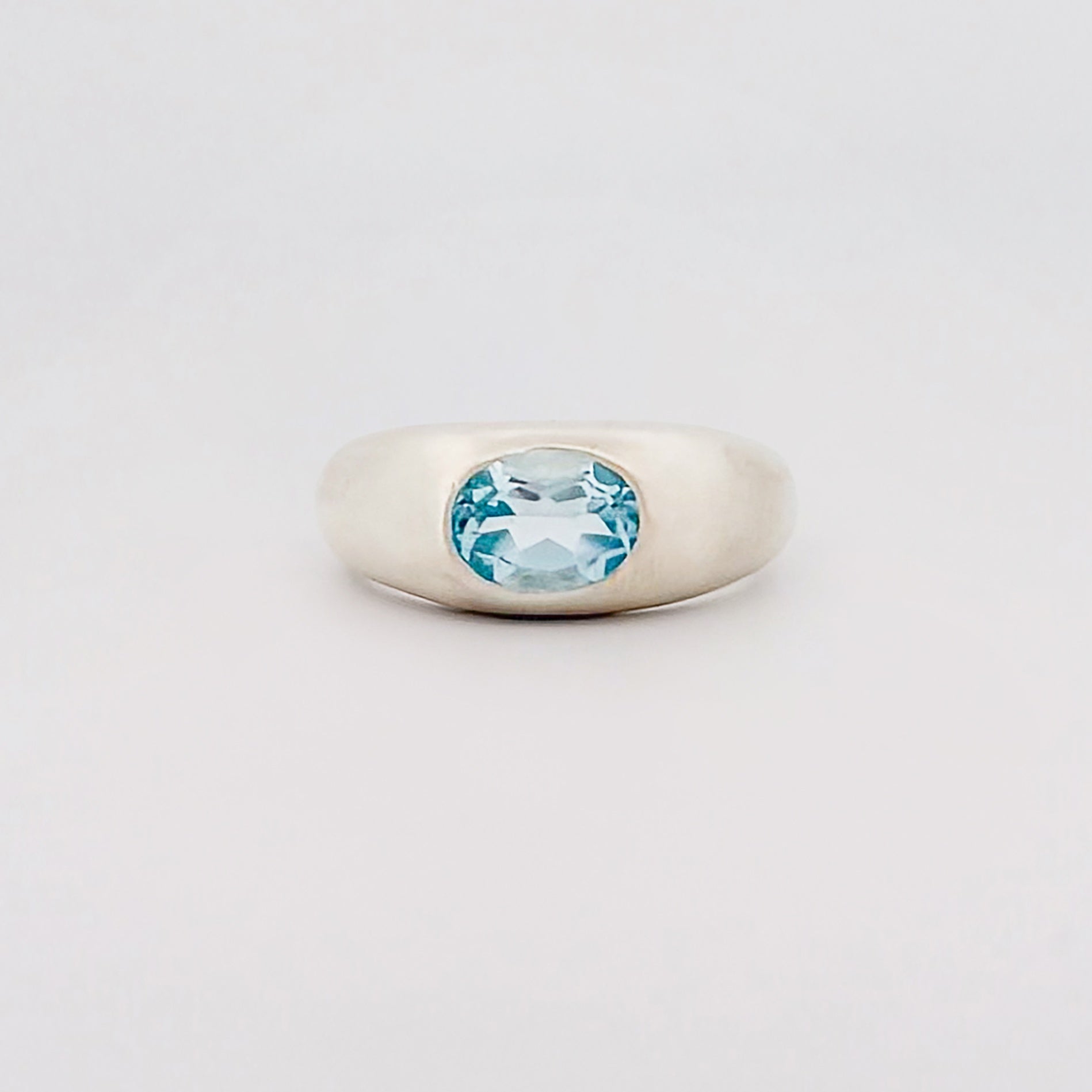 MANON Ring in recycled sterling silver, set with a bezel-set oval Swiss blue topaz. Handmade in Melbourne by AGOVIA.