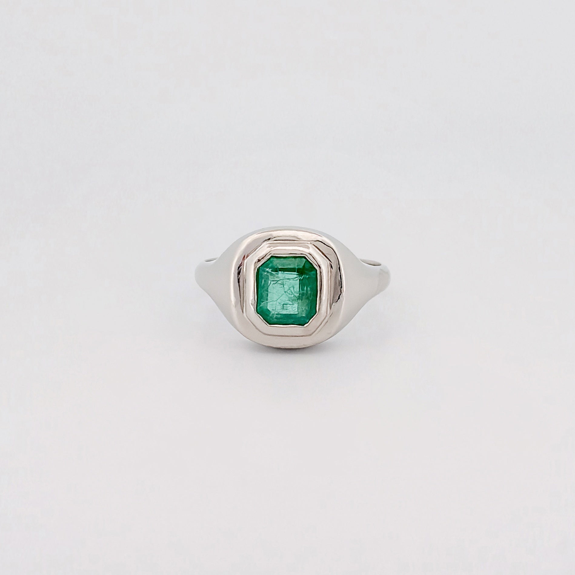 CEDAR signet ring in recycled platinum, set with an emerald-cut Zambian emerald. Handmade in Melbourne by AGOVIA.