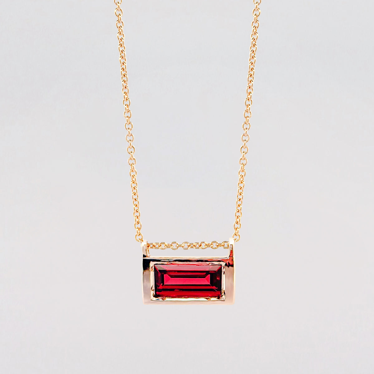 VIVIANA Pendant in 9ct yellow gold, set with a baguette-cut Almandine garnet. Handmade in Melbourne by AGOVIA.